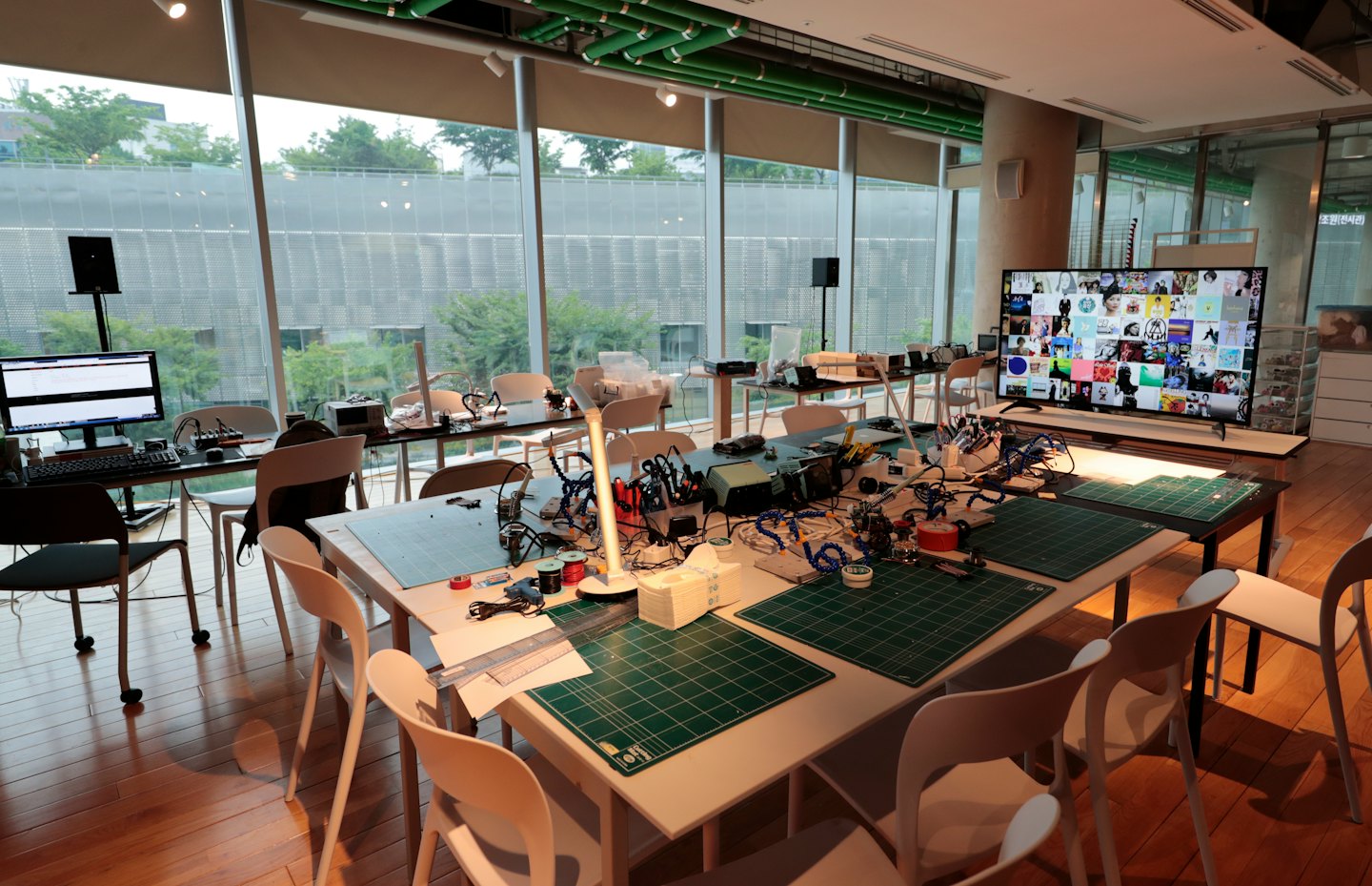 Electronics workshop with tables full of components and computers.